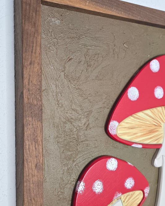Close up view of the texture in the art piece with carved polka dot mushrooms