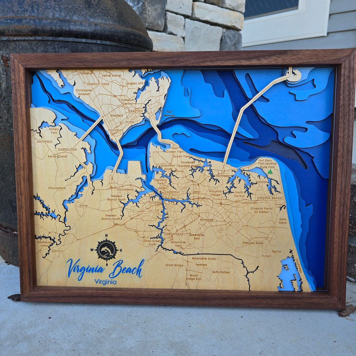 Wooden bathymetric map of Virginia Beach with blue water features, framed in walnut