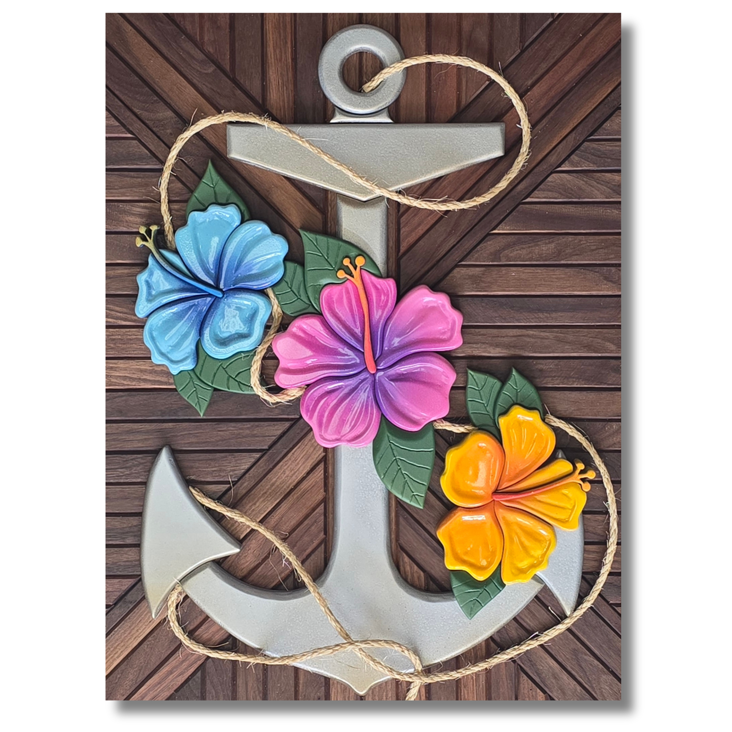 Zoomed out picture of carved anchor with hibiscus flowers adorned on the front with rope fouling the anchor