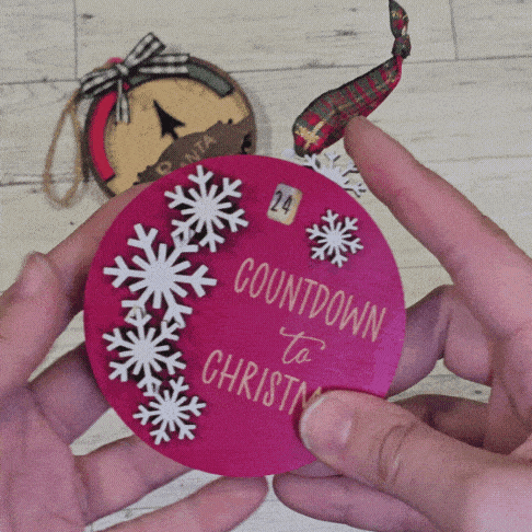 gif of the movable pieces of the Christmas countdown ornament with snowflakes on a red bauble design