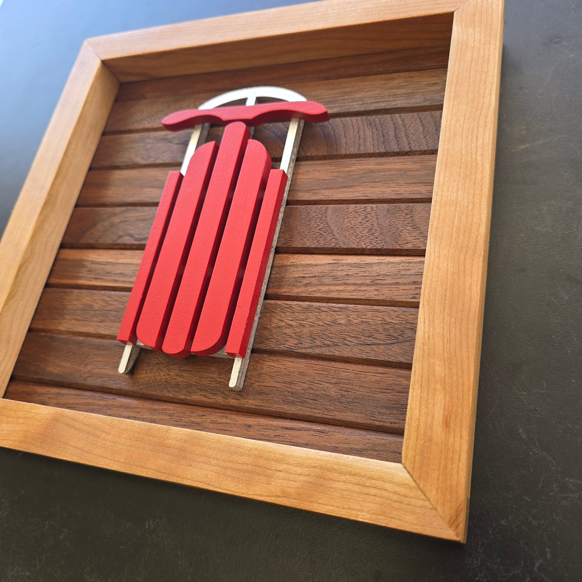 Red old fashioned sled on walnut backer, framed with Cherry wood