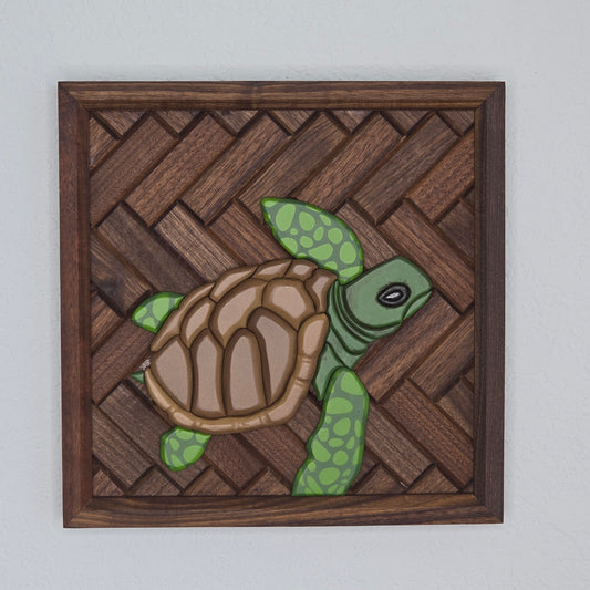 3D green sea turtle wood art with spotted emerald flippers and a brown shell, mounted on a dark basket-weave wood background with a dark wood frame.