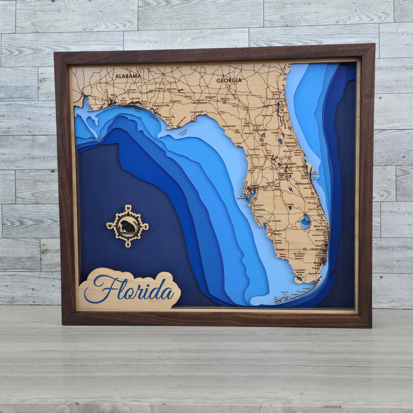3D bathymetric map of Florida with wooden frame and 'Florida' label.