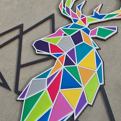 Colorful geometric deer sculpture on a concrete surface