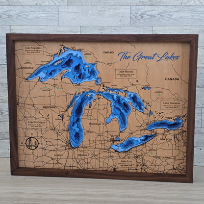 Map of The Great Lakes with wooden frame and blue water features on a light gray surface