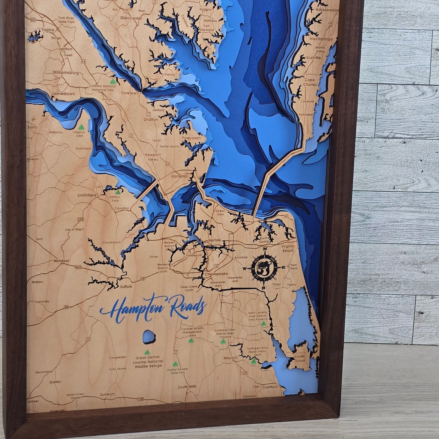 Wooden map of Hampton Roads with bathymetric details on a wooden surface