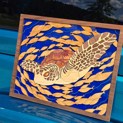 Decorative wall art with a turtle design on a blue background