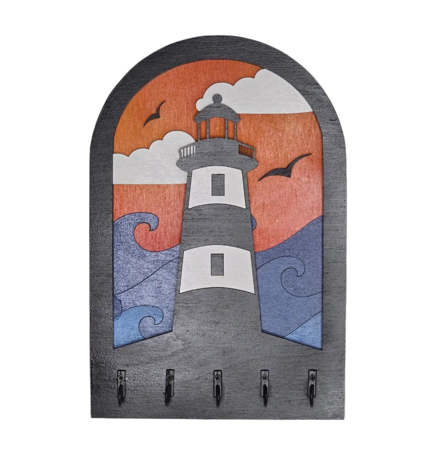 Decorative keyholder with a lighthouse in front of waves and clouds. 