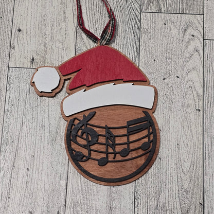 Wooden cutout of a Santa hat with musical notes on a wooden surface