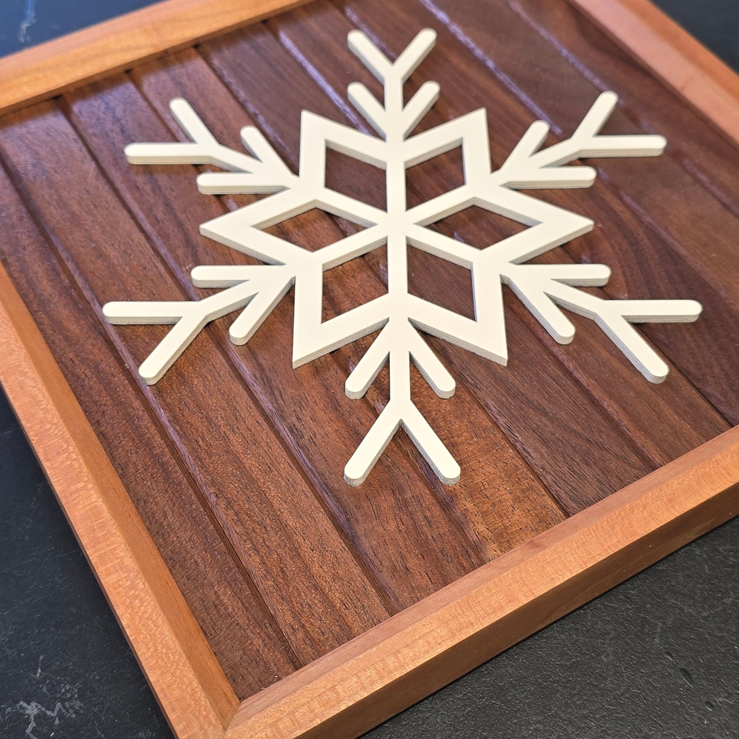 Wooden snowflake on walnut wooden backer and cherry wood frame