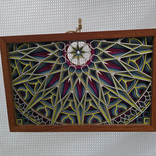 Decorative painted panel with geometric patterns in a wooden frame on a textured gray background