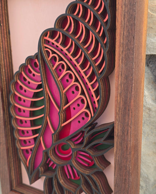 Close-up detail of layered laser-cut wood art showing the depth, geometric patterns, and magenta colors of the "Tidal Bloom" seashell design.