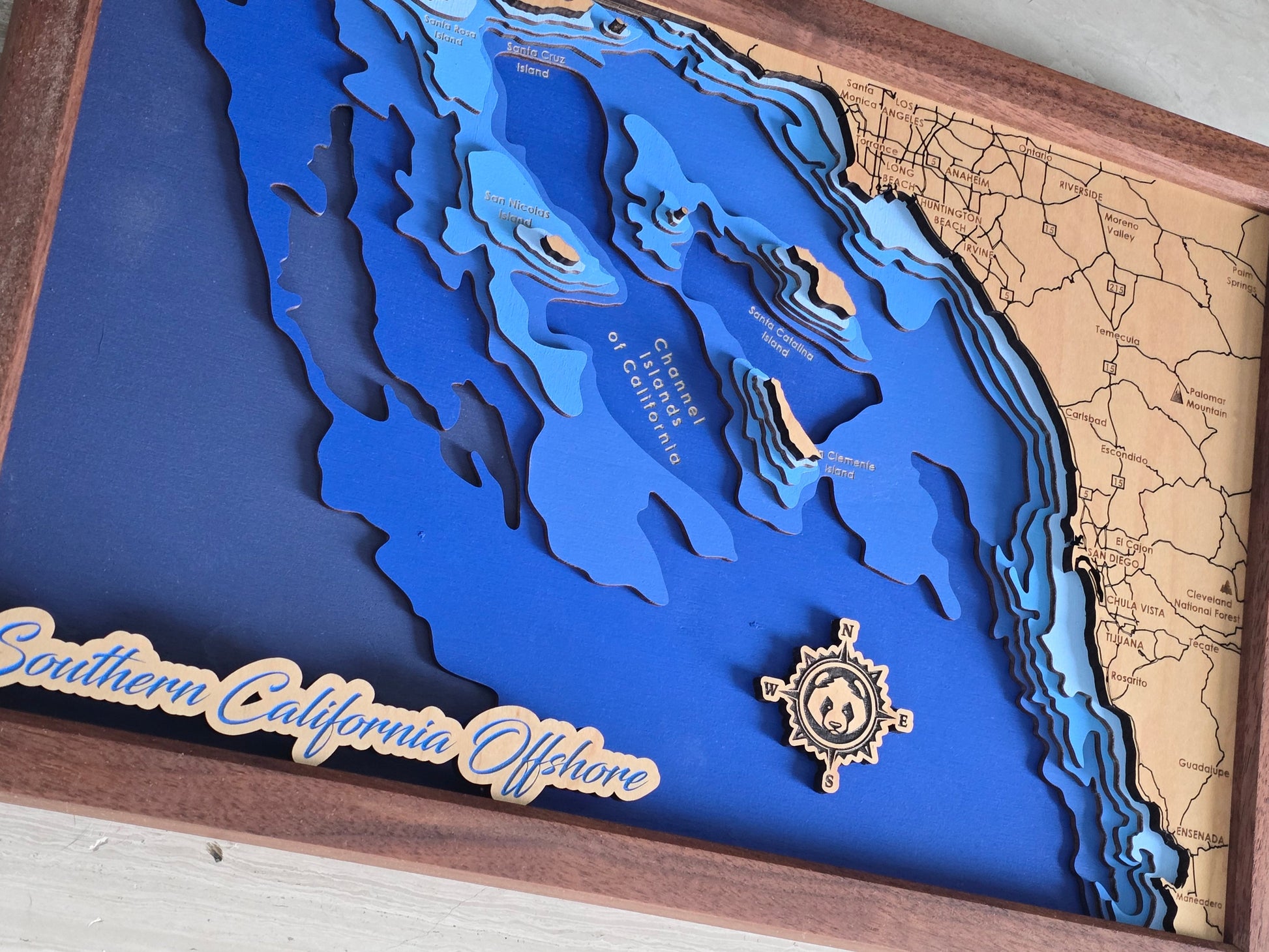 3D bathymetric map of southern California Offshore with a wooden frame and panda head in the compass rose.