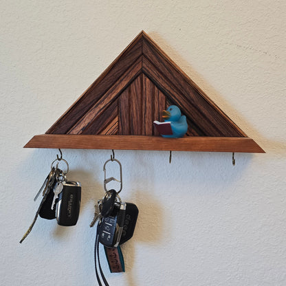 Wooden key holder with keys attached on a white wall
