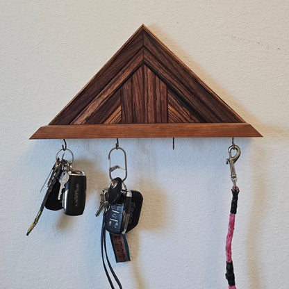 Wooden key holder with keys and lanyards on a white surface